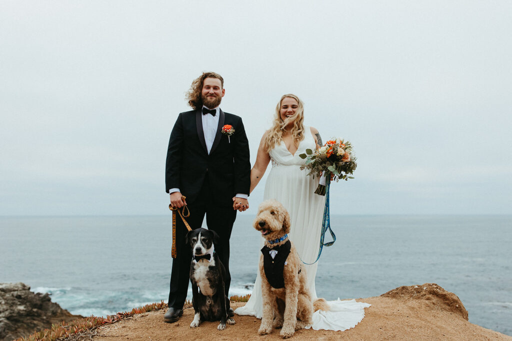 couple pose with their dog at their big sur elopement
