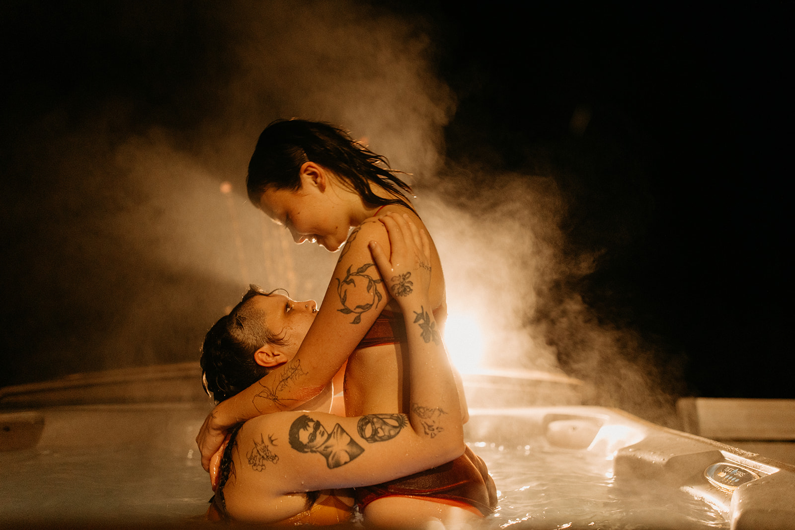 steamy couples photoshoot in a hot tub at an airbnb