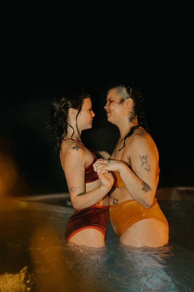 steamy couples photoshoot in a hot tub at an airbnb